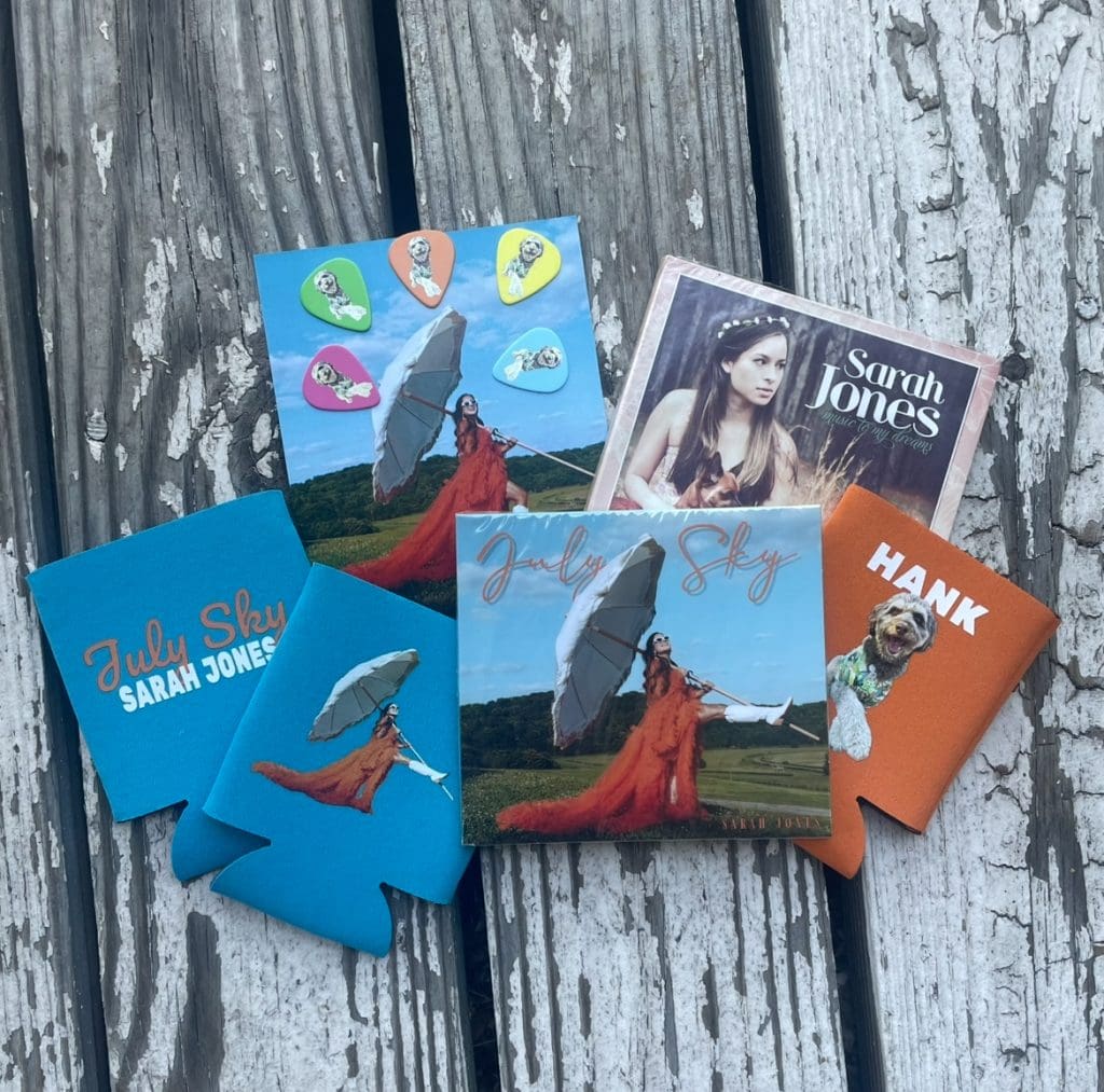 Sarah Jones bundle offer: "July Sky" CD, "July Sky" signed photo, "July Sky" koozie, Hank koozie, "music to my dreams" CD, guitar picks