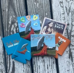 Sarah Jones bundle offer: "July Sky" CD, "July Sky" signed photo, "July Sky" koozie, Hank koozie, "music to my dreams" CD, guitar picks